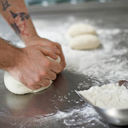 dough gets kneaded by hand